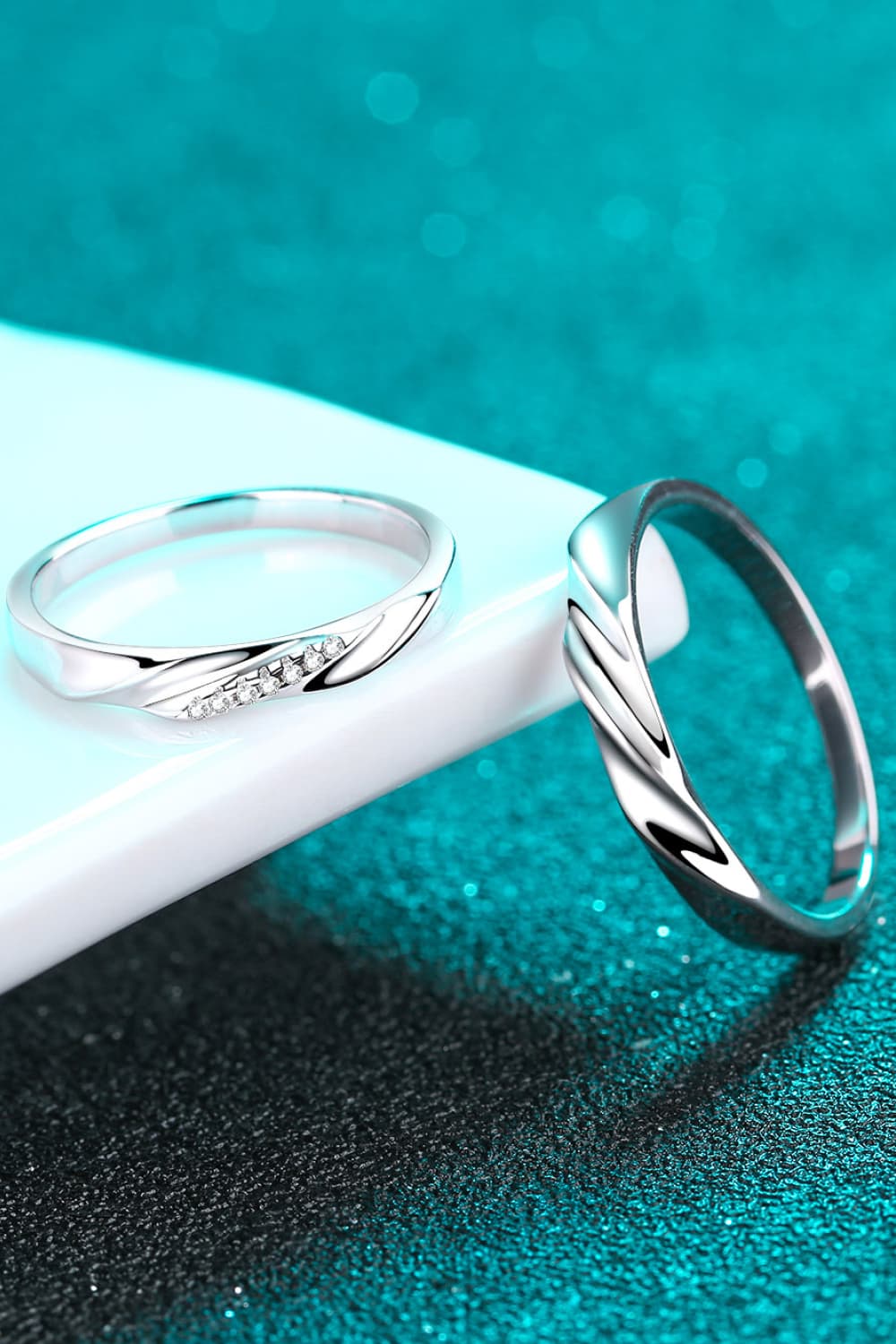 Minimalist 925 Sterling Silver Rhodium-Plated Ring displayed on a shiny surface with a teal background.