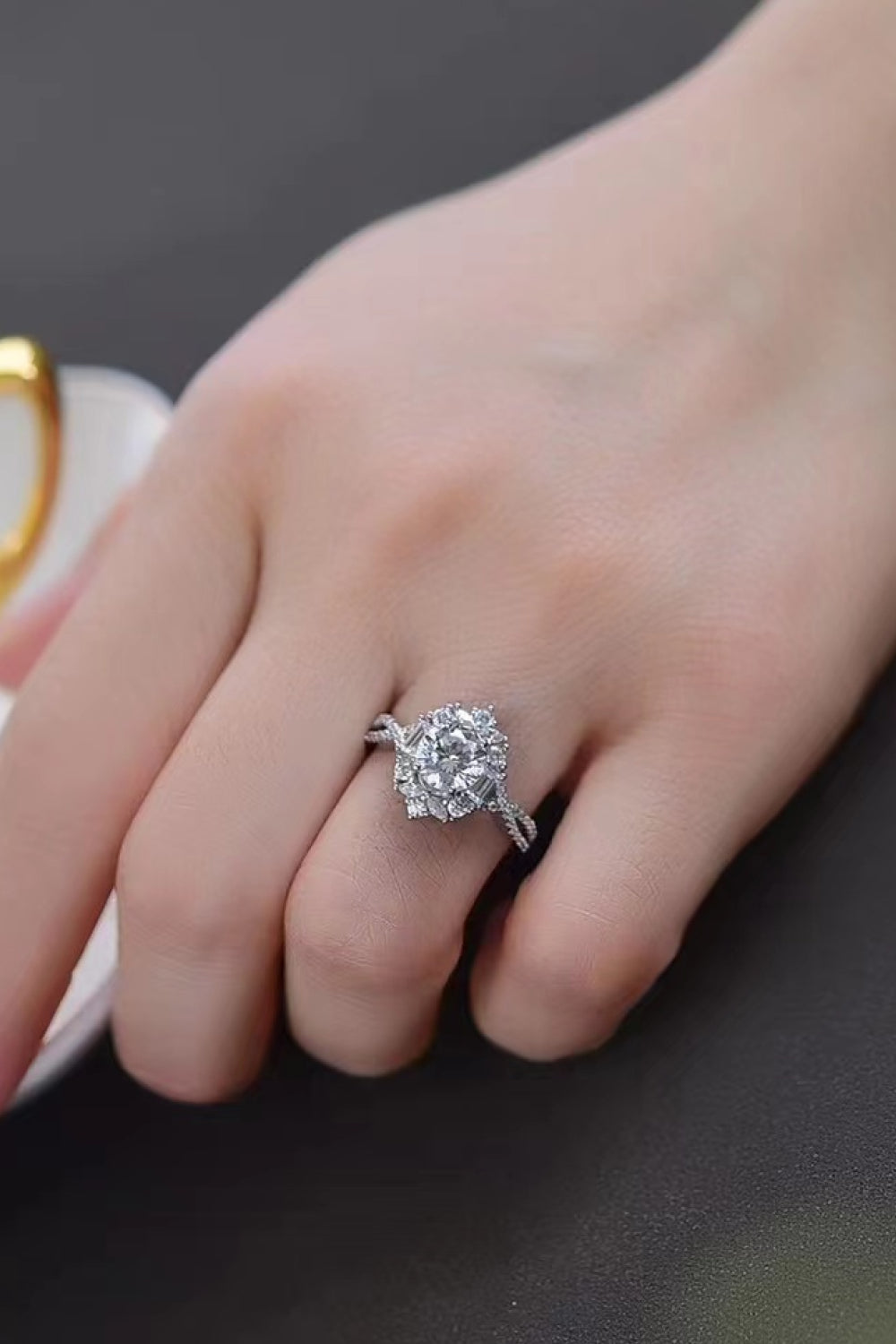 Floral 2 Carat Moissanite Crisscross Engagement Ring displayed on a hand, showcasing its elegant flower-inspired design.
