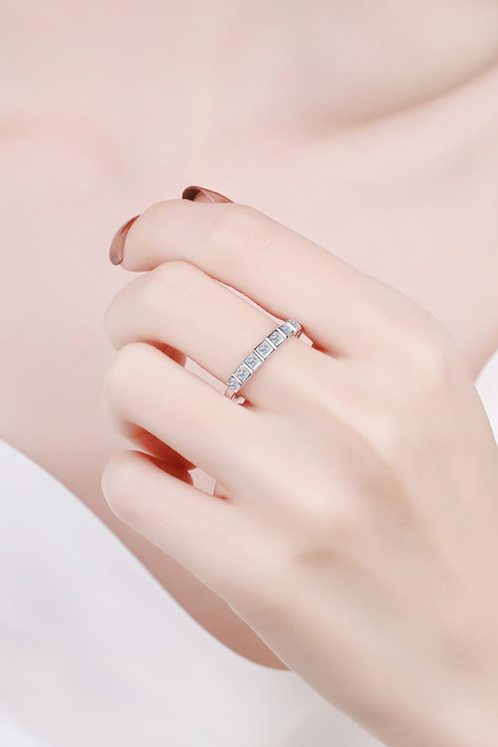 Moissanite Rhodium-Plated Half-Eternity Ring worn on a woman's hand with minimalist styling.